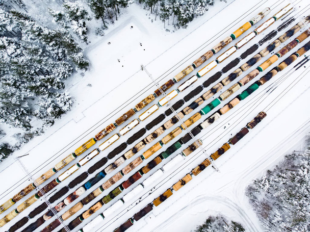 Aerial view of colorful freight train cars on the railway station. Wagons with goods on railroad. Heavy industry. Industrial conceptual scene with trains. - Valokuva, kuva