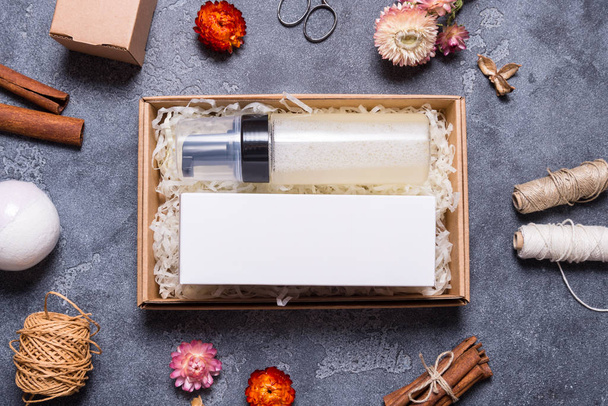 Mock up, cream bottle and carton box on grey background - Фото, изображение