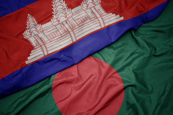 ondeando colorida bandera de bangladesh y bandera nacional de cambodia
. - Foto, Imagen