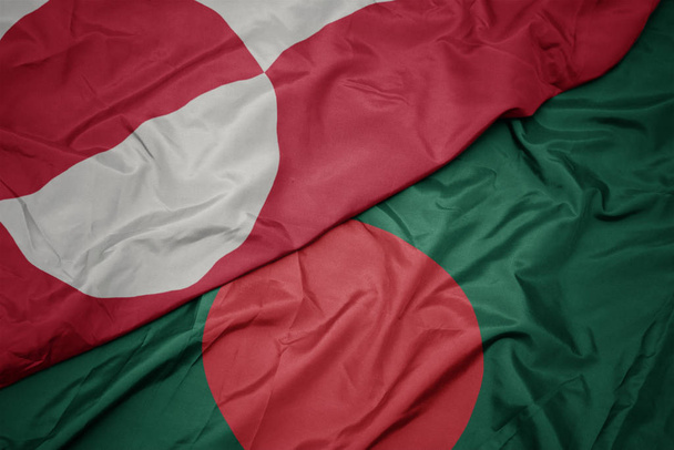 ondeando colorida bandera de bangladesh y bandera nacional de Groenlandia
. - Foto, Imagen