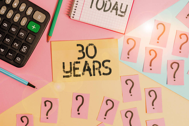 Conceptual hand writing showing 30 Years. Business photo text Remembering or honoring special day for being 30 years in existence Mathematics stuff and writing equipment on pastel background. - Photo, Image
