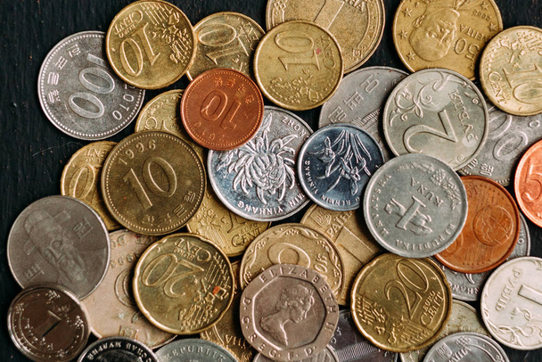 different coins of the world on the table - Fotó, kép