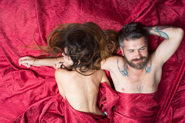 Man and woman with half covered bodies lie together - Photo, image