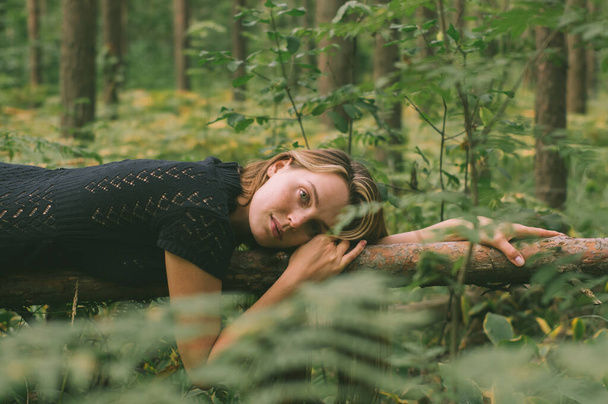 Portrait of young beautiful girl in black dress in forest  - Foto, Bild