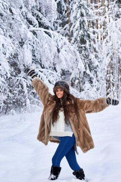 Meisje loopt door de sneeuw in het bos. Kaukasisch meisje - Foto, afbeelding
