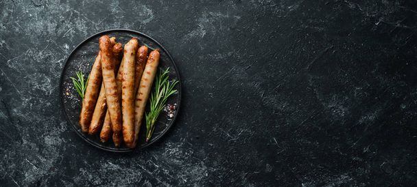 Grilled sausages with rosemary and spices. Top view. Free space for your text. - Fotó, kép