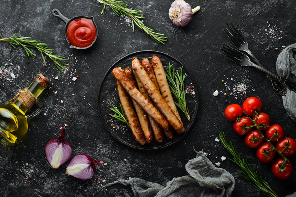 Grilled sausages with rosemary and spices. Top view. Free space for your text. - Фото, изображение