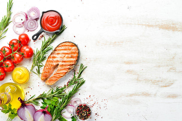Grilled salmon steak with rosemary and spices. Top view. Free space for your text. - Фото, изображение
