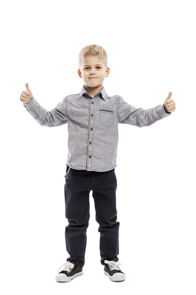 Standing cute boy of preschool age, thumbs up. Full height. Isolated over white background. - Photo, Image