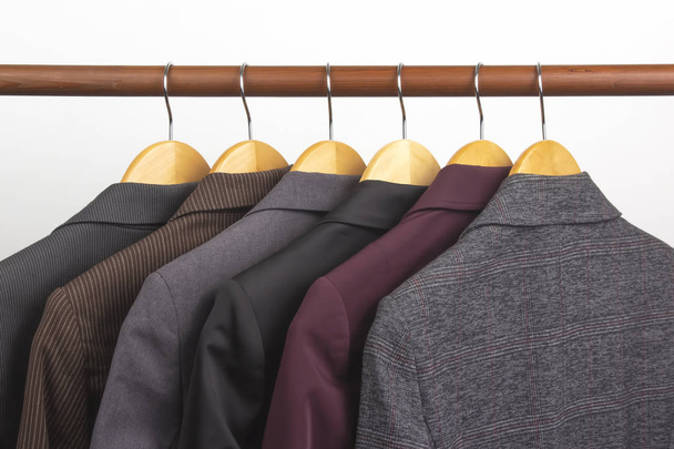 Different women's office classic jackets hang on a hanger for st - Фото, изображение
