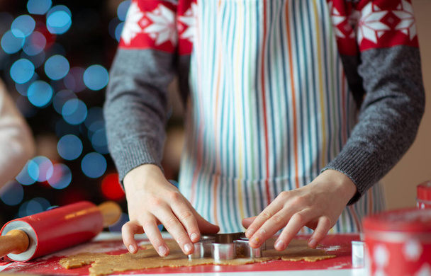 Closeup photo of children's hands making ginger cookies for Chri - Fotó, kép