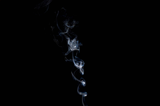 Smoke  on a black background, abstract photo with swirls in the air - Фото, изображение
