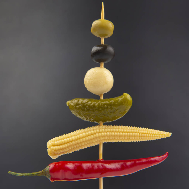 Oliwki, ogórek marynowany, papryka czerwona, grzyby i kukurydza na - Zdjęcie, obraz
