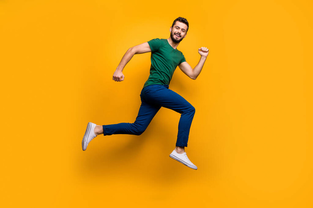 Full size photo of cheerful guy jump run fast for discounts wear modern clothing isolated over yellow color background - Fotó, kép