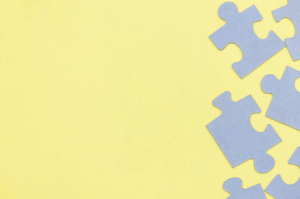 Puzzle pieces on yellow background. Top view. Copy space. - Valokuva, kuva