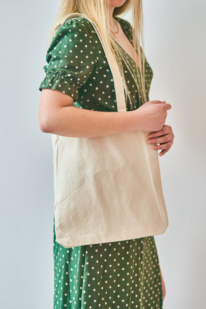 A Girl is holding blank cotton eco tote bag, design mockup. - Foto, Imagem