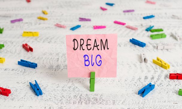Writing note showing Dream Big. Business photo showcasing seeking purpose for your life and becoming fulfilled in process Green clothespin white wood background reminder office supply. - Photo, Image