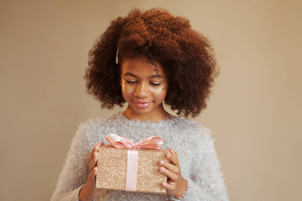 Cute festive girl holding a gift box  - Foto, Imagem