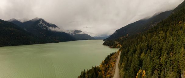 Beautiful Aerial Panoramic Landscape View of a Scenic road in Canadian Nature during a Cloudy Autumn Day. Taken at Lillooet Lake, Pemberton, British Columbia, Canada. - Fotoğraf, Görsel