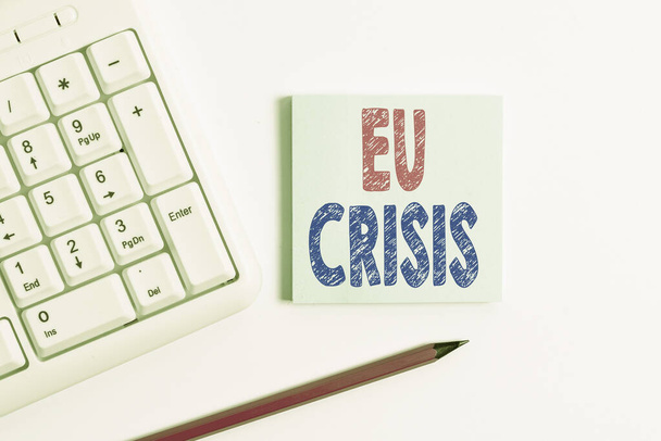 Handwriting text Eu Crisis. Concept meaning eurozone state unable to repay or refinance their government debt White pc keyboard with empty note paper and pencil above white background. - Photo, Image