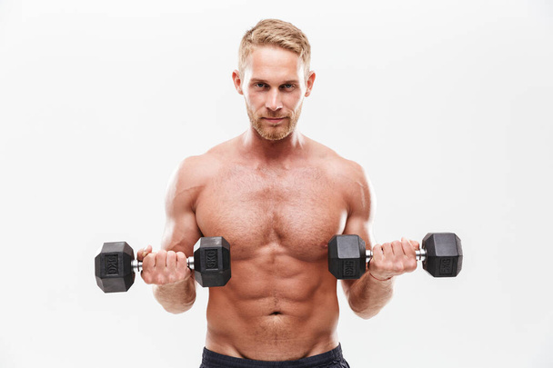Confident attractive young muscular sportsman standing - Foto, imagen