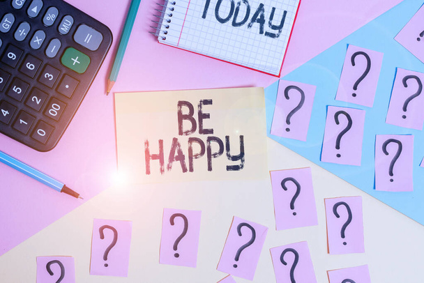 Conceptual hand writing showing Be Happy. Business photo text to live every moment as the last love your life work family Mathematics stuff and writing equipment on pastel background. - Photo, Image