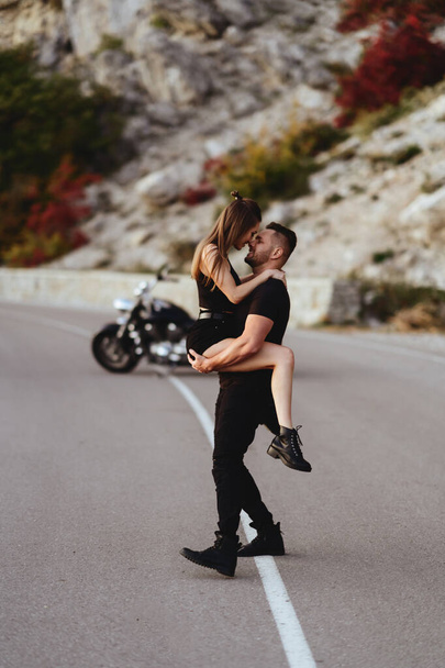 Portrait of beautiful young couple on a motorcycle. - Foto, immagini