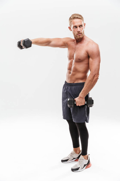 Confident attractive young muscular sportsman standing - Fotoğraf, Görsel