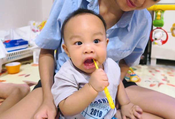 Asian baby boy, 7 months old trying brushing teeth - Photo, Image