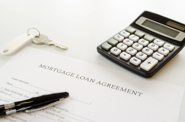 Mortgage loan agreement sign contract concept with calculator, keys and pen on mortgage form or contract - Photo, Image