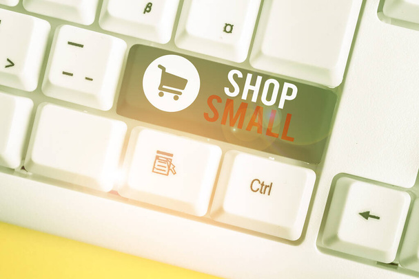 Conceptual hand writing showing Shop Small. Business photo text nationwide movement that celebrates small businesses every day White pc keyboard with note paper above the white background. - Photo, Image