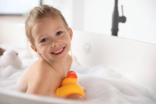 Cute little girl taking bubble bath at home - Φωτογραφία, εικόνα
