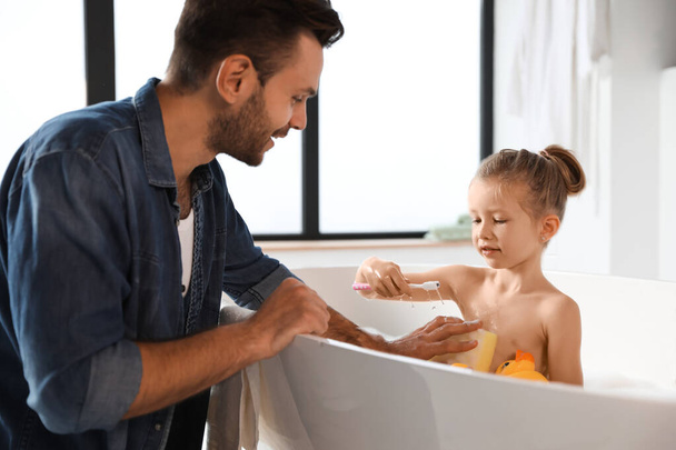 Young father with cute little daughter in bathroom - Φωτογραφία, εικόνα