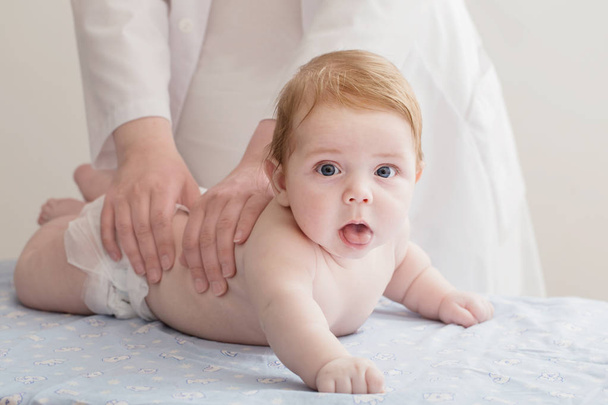 nurse does massage to baby - Foto, immagini