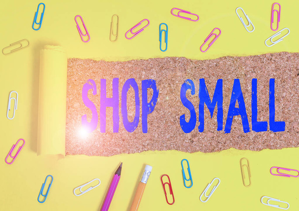 Conceptual hand writing showing Shop Small. Business photo text nationwide movement that celebrates small businesses every day Stationary and torn cardboard on a wooden classic table backdrop. - Photo, Image