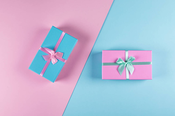 Two pastel gift boxes on a blue-pink background. - Photo, Image