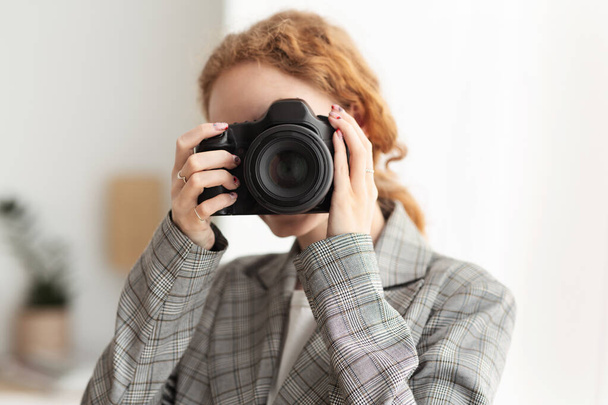 Successful photographer taking photo with professional camera - 写真・画像