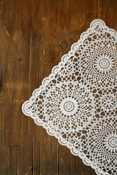 Wooden background with white lace vintage napkin - Photo, Image