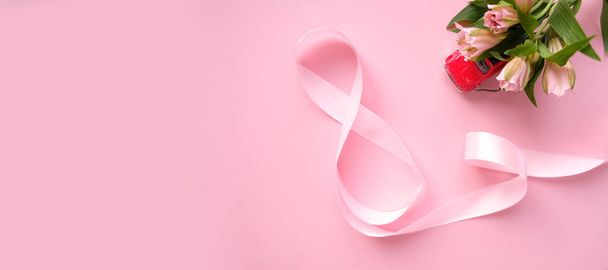 Pink ribbon in the shape of a eight - Zdjęcie, obraz