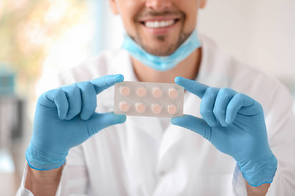 Doctor with pills in clinic, closeup - Photo, image