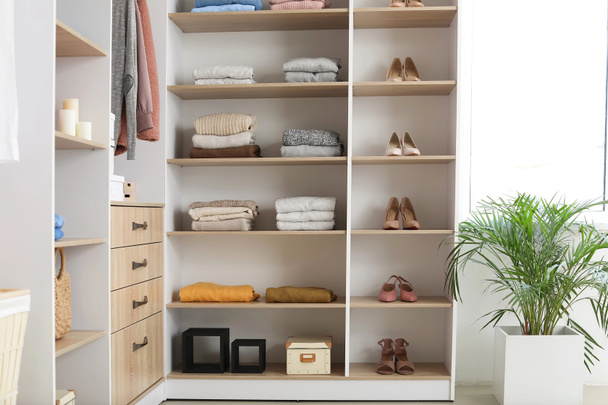 Wardrobe with stacks of clean clothes - Photo, Image