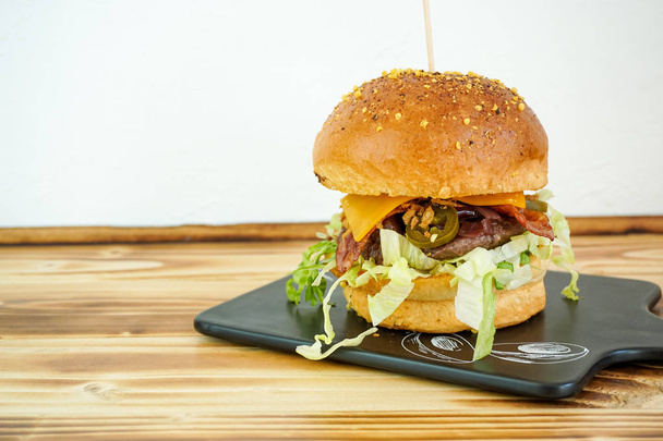 Meaty hamburger in a restaurant - Photo, Image