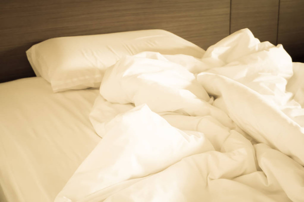 White crumpled bed sheet and messy pillows in a hotel room - Photo, Image