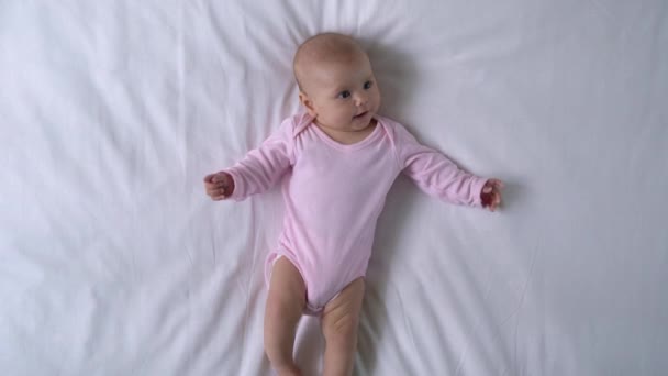 Charming baby playing legs and arms, chewing sweet tiny fingers, happy infancy - Footage, Video