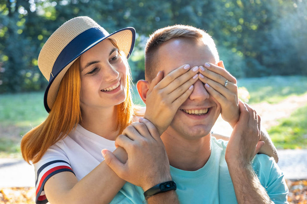 Happy teenage couple having fun together outdoors in sunny summe - Photo, image
