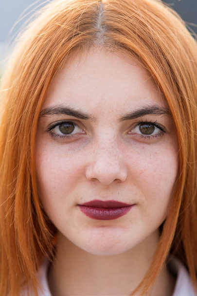 Closeup face portrait of a girl with red hair and clear eyes. - Photo, Image