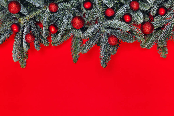 Christmas background with red balls on fir brunches. - Φωτογραφία, εικόνα
