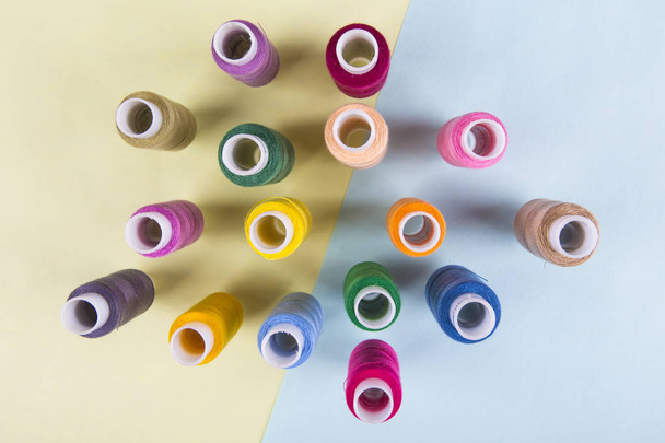 Lot of colored thread spools - Фото, изображение