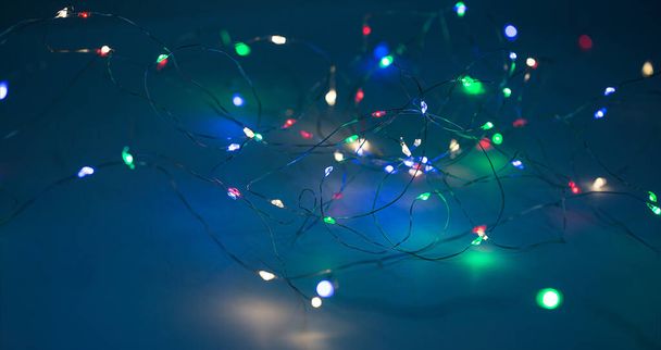 Christmas lights on dark blue background with copy space. Decorative garland - Foto, immagini