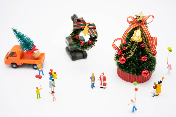 Family Miniature people standing on Christmas tree Celebrate Chr - Photo, Image